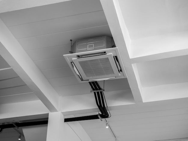 ceiling-mounted-cassette-type-air-conditioner-decoration-near-lights-white-concrete-construction-building-loft-style-interior-ceiling-type-air-conditioning-unit-with-ventilation-system_36367-7910