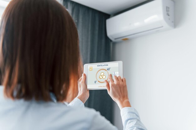 modern-technologies-rear-view-woman-that-is-indoors-controlling-smart-home_146671-55072